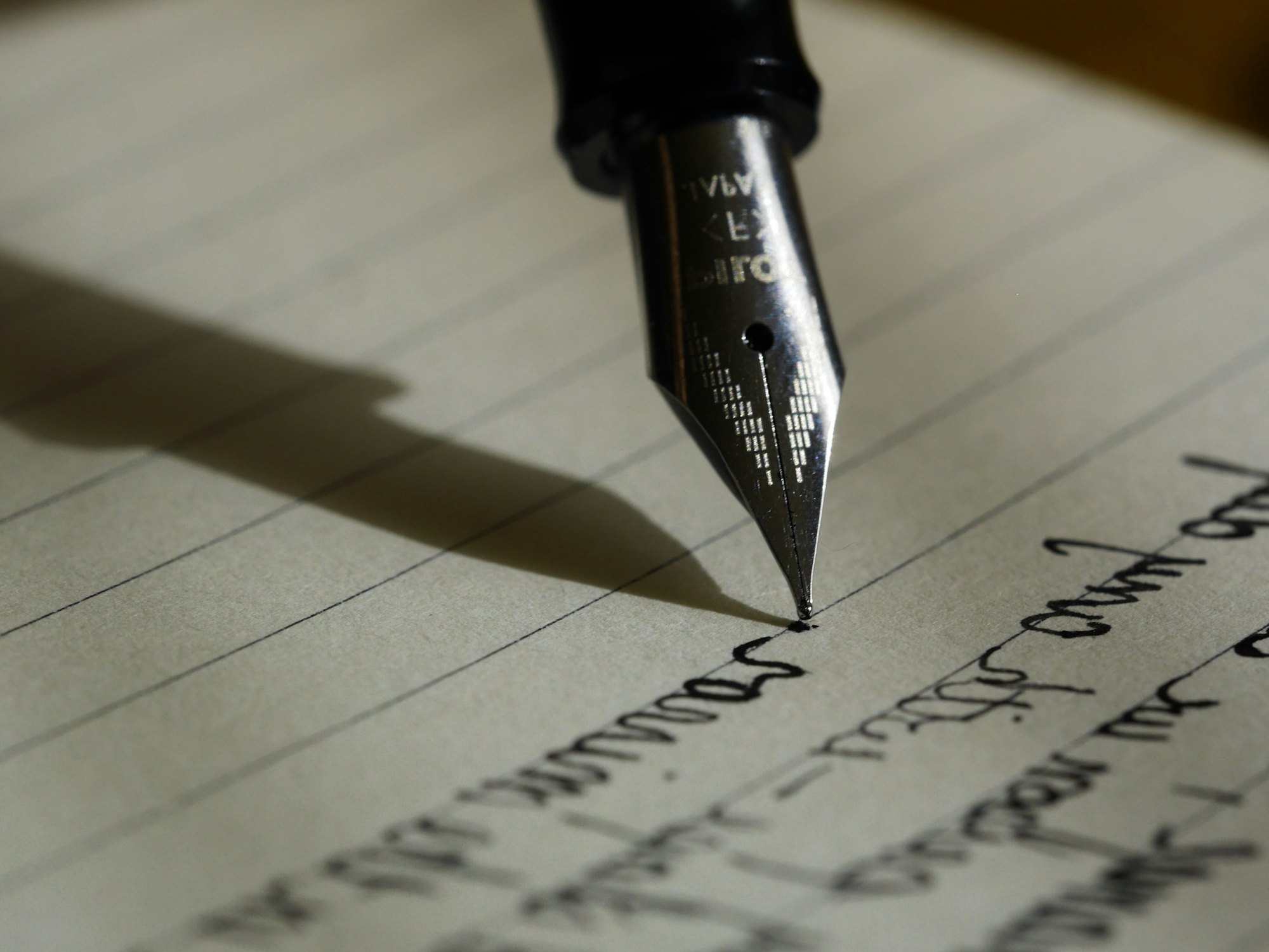 A fountain pen writing on lined paper, documenting the record