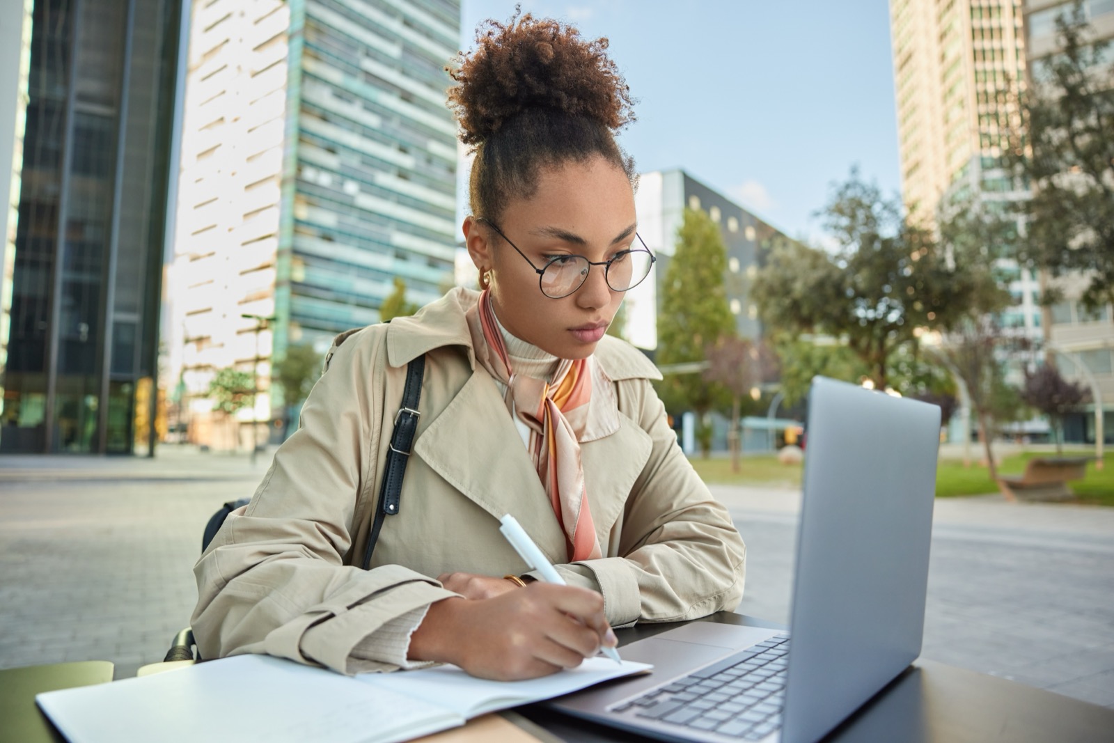 A young writer taking notes at a laptop, carrying Ida's pen today