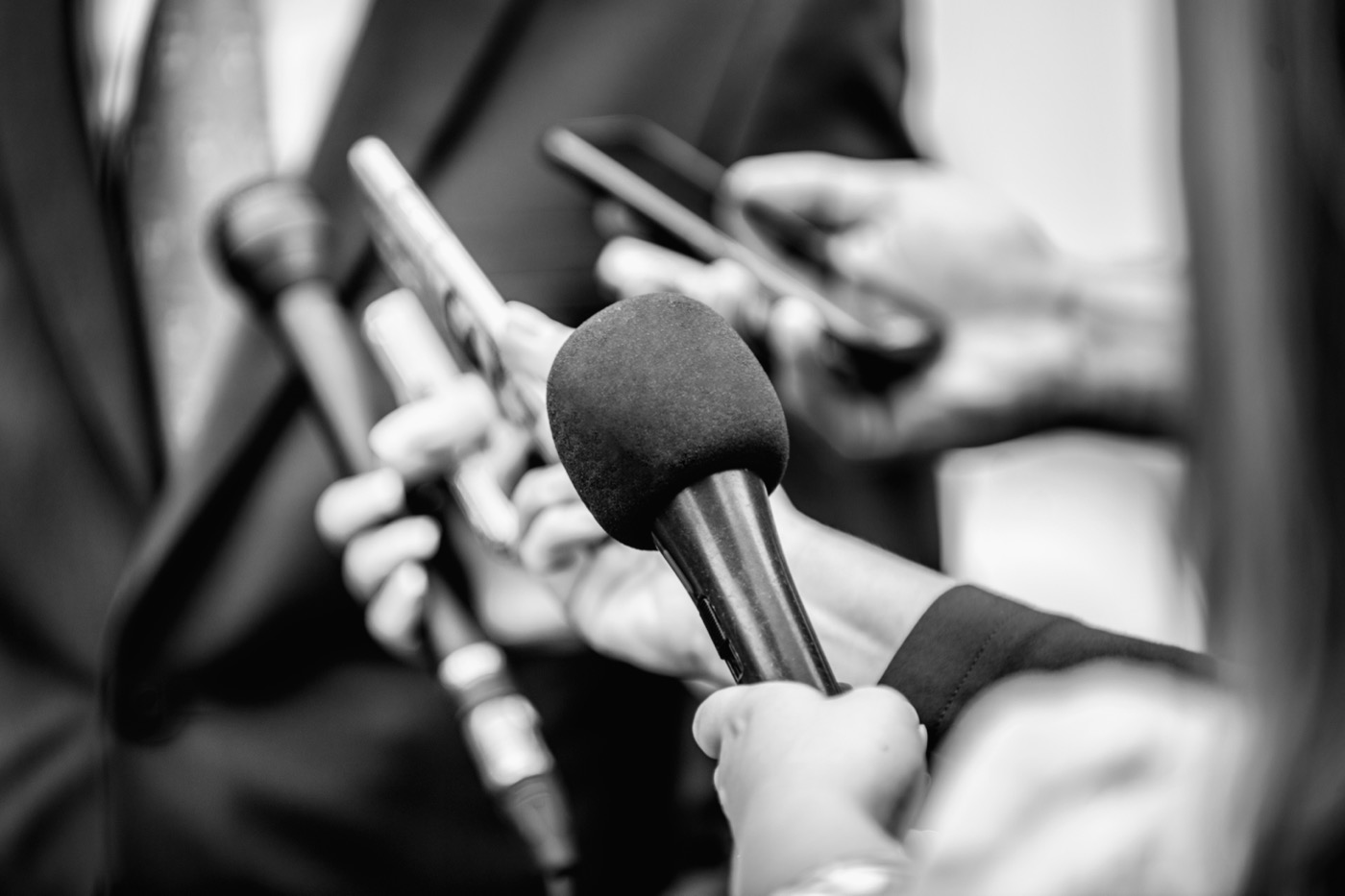 Microphones raised at a press interview
